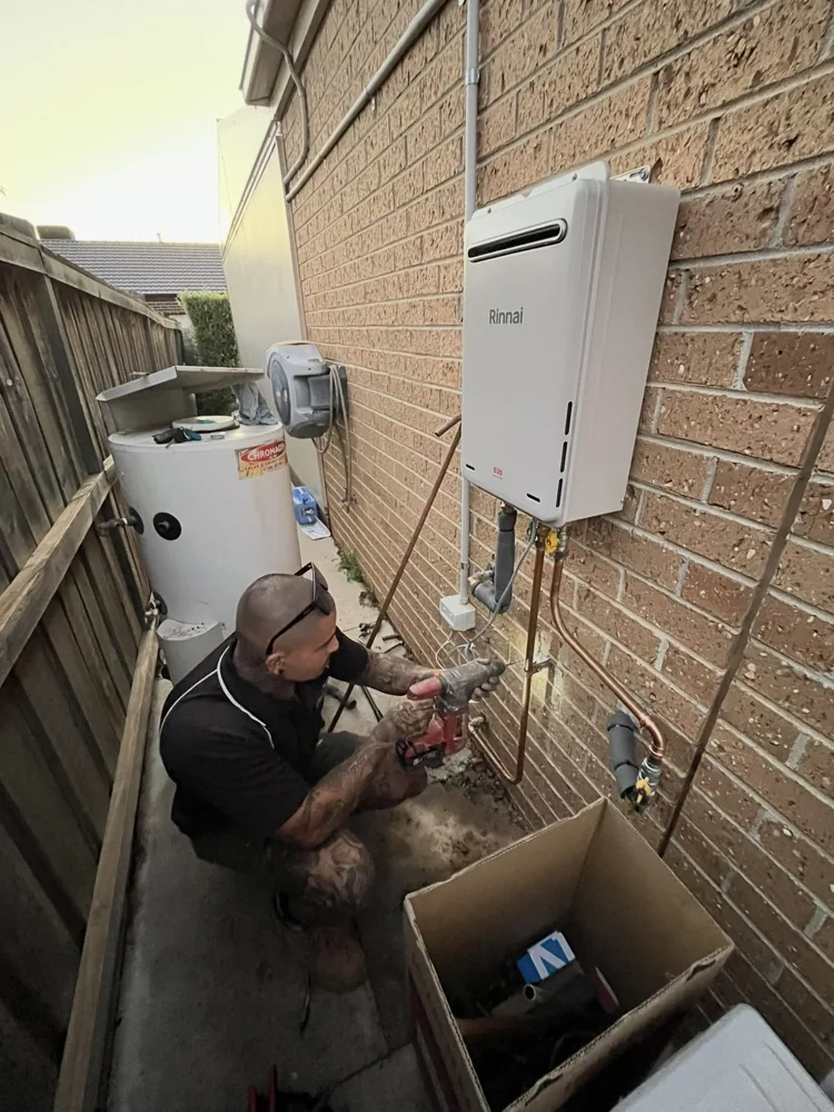 Priority Plumbing Melbourne, a Dossis Digital client, installing a hot water system