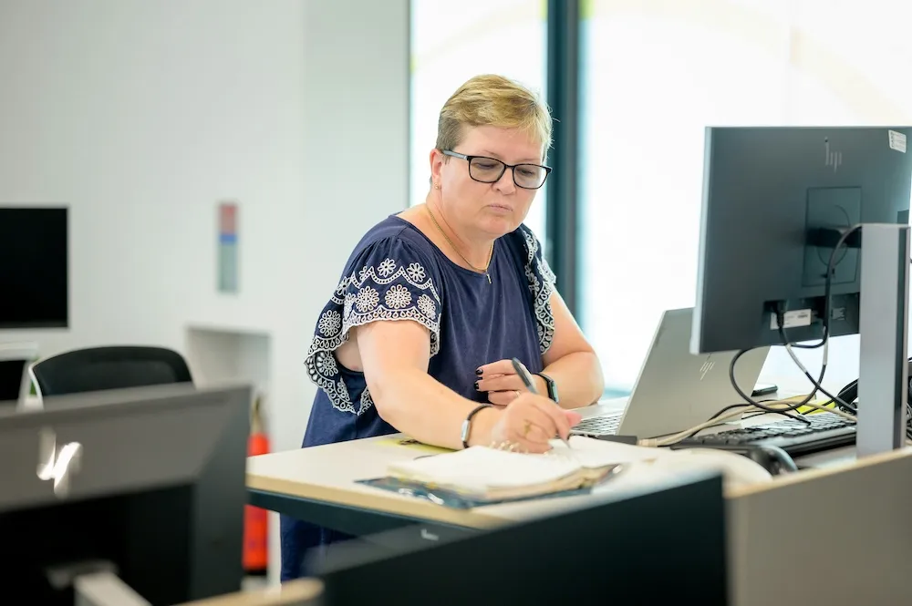 Bookkeeper reviewing financial records at a desk